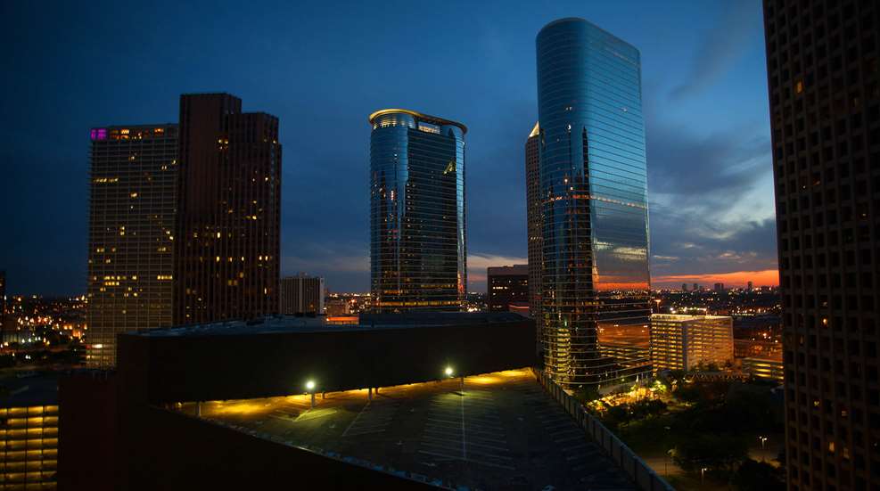 Sunset city skyline towers buildings yellow lights