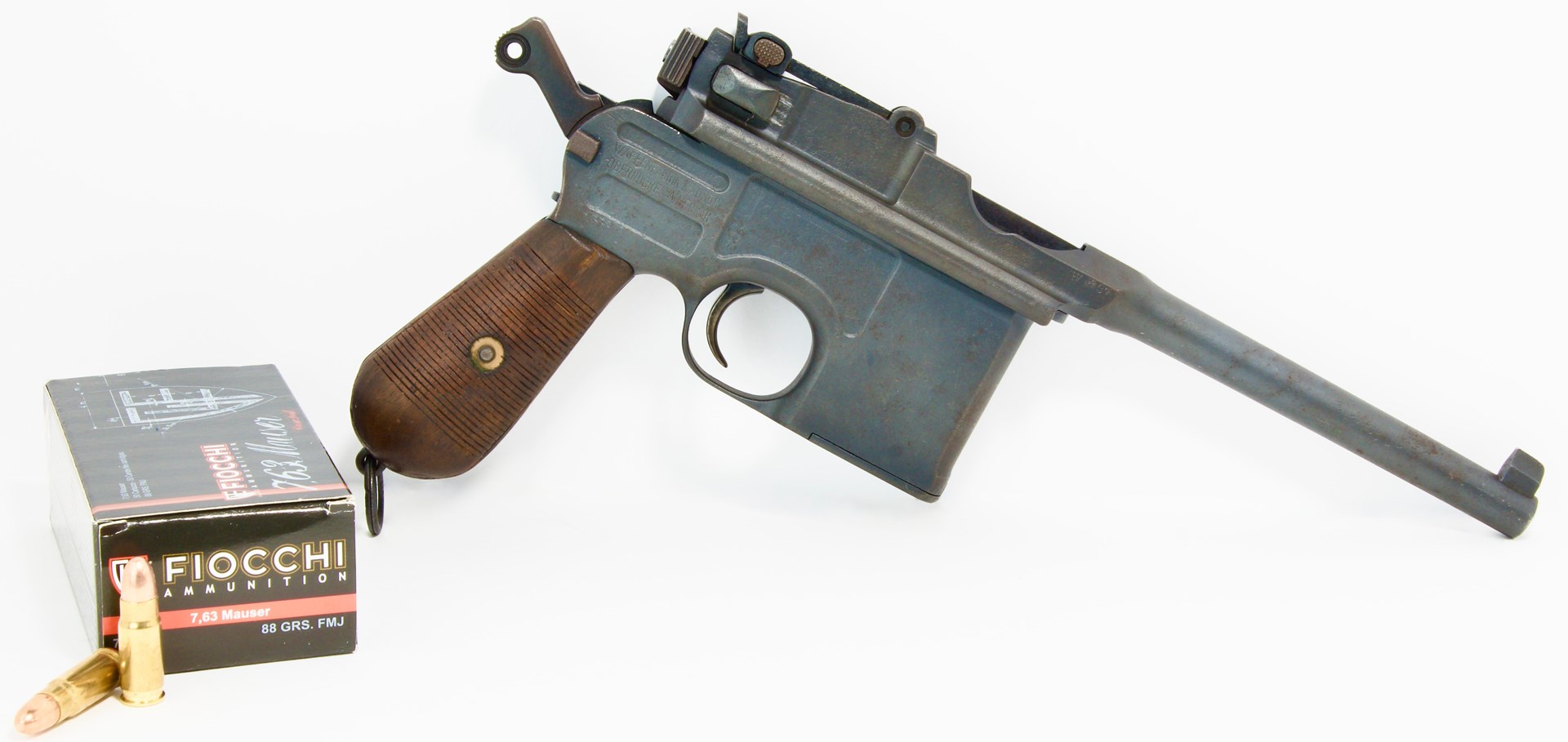 right-side view of Mauser C96 pistol semi-automatic white background fiocchi ammunition box foreground