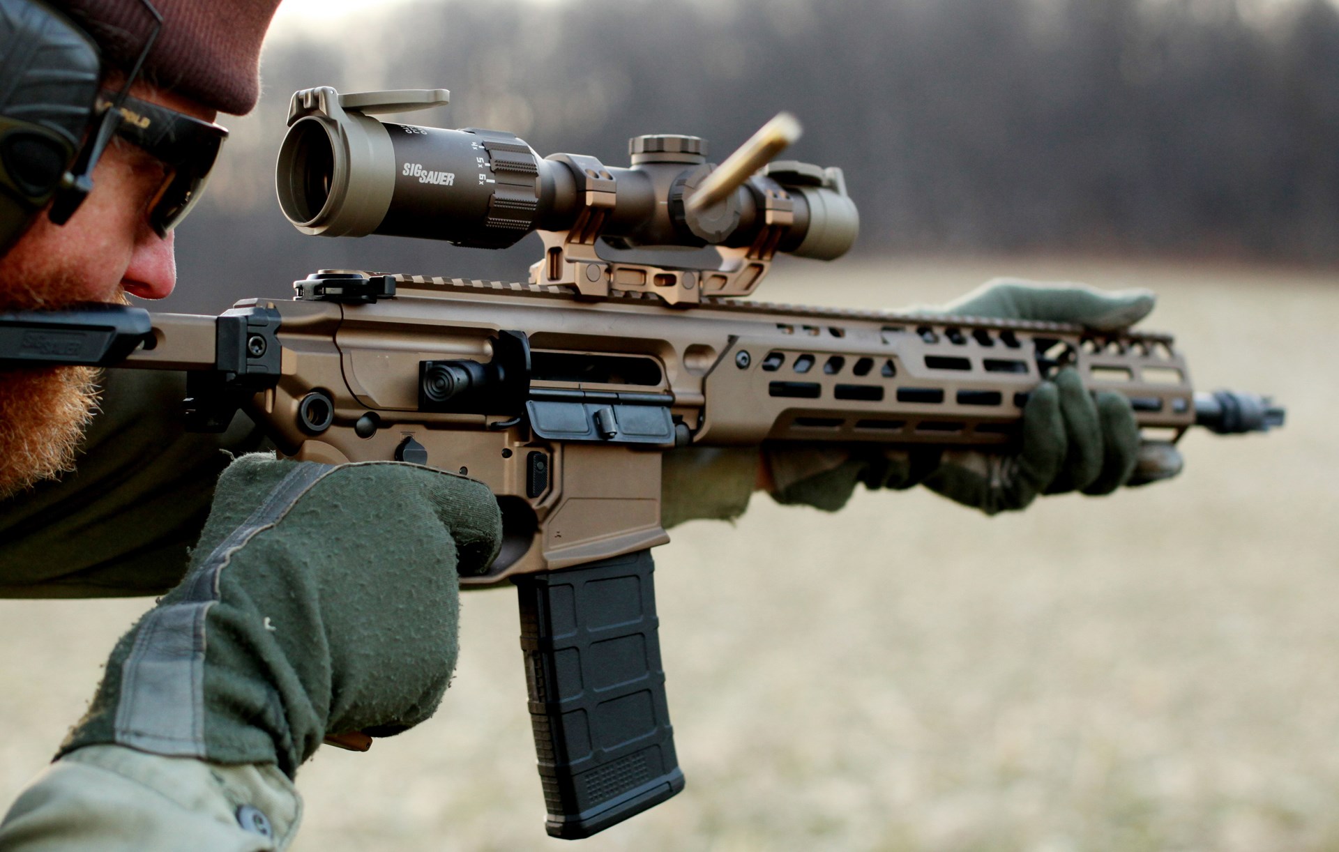 bearded man outdoors shooting sig sauer mcx spear lt