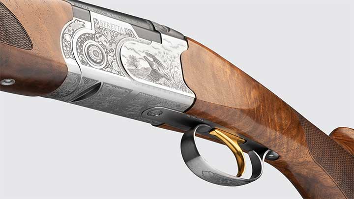 A view of the engravings on the receiver and gold colored trigger on the Beretta 687 Silver Pigeon III.