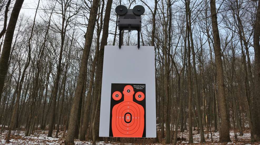 Dynamic Range’s X1 target system in woods snow trees white target backer with humanoid target and bullseyes