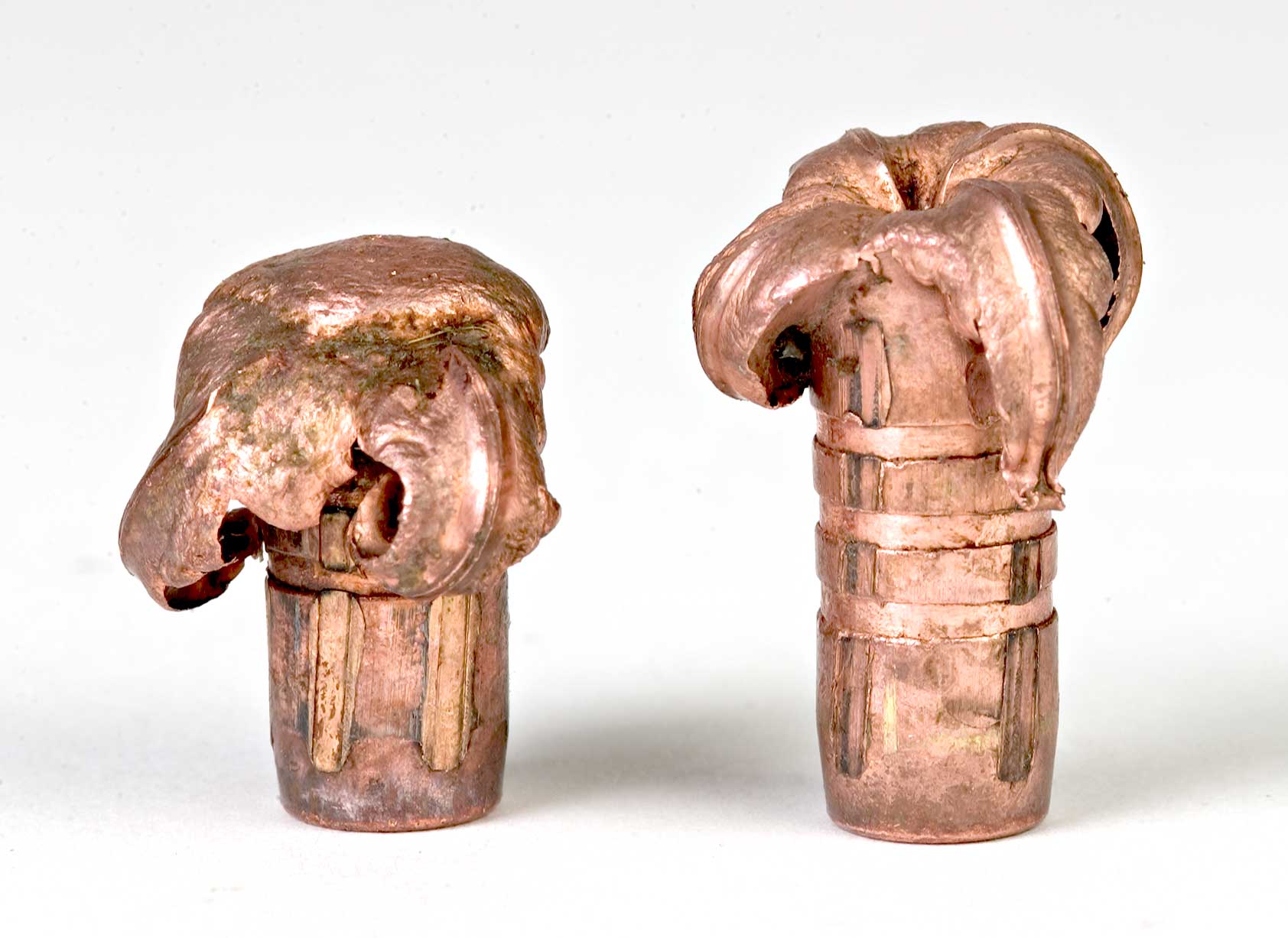 two copper bullets row deformed metal mushroom shape