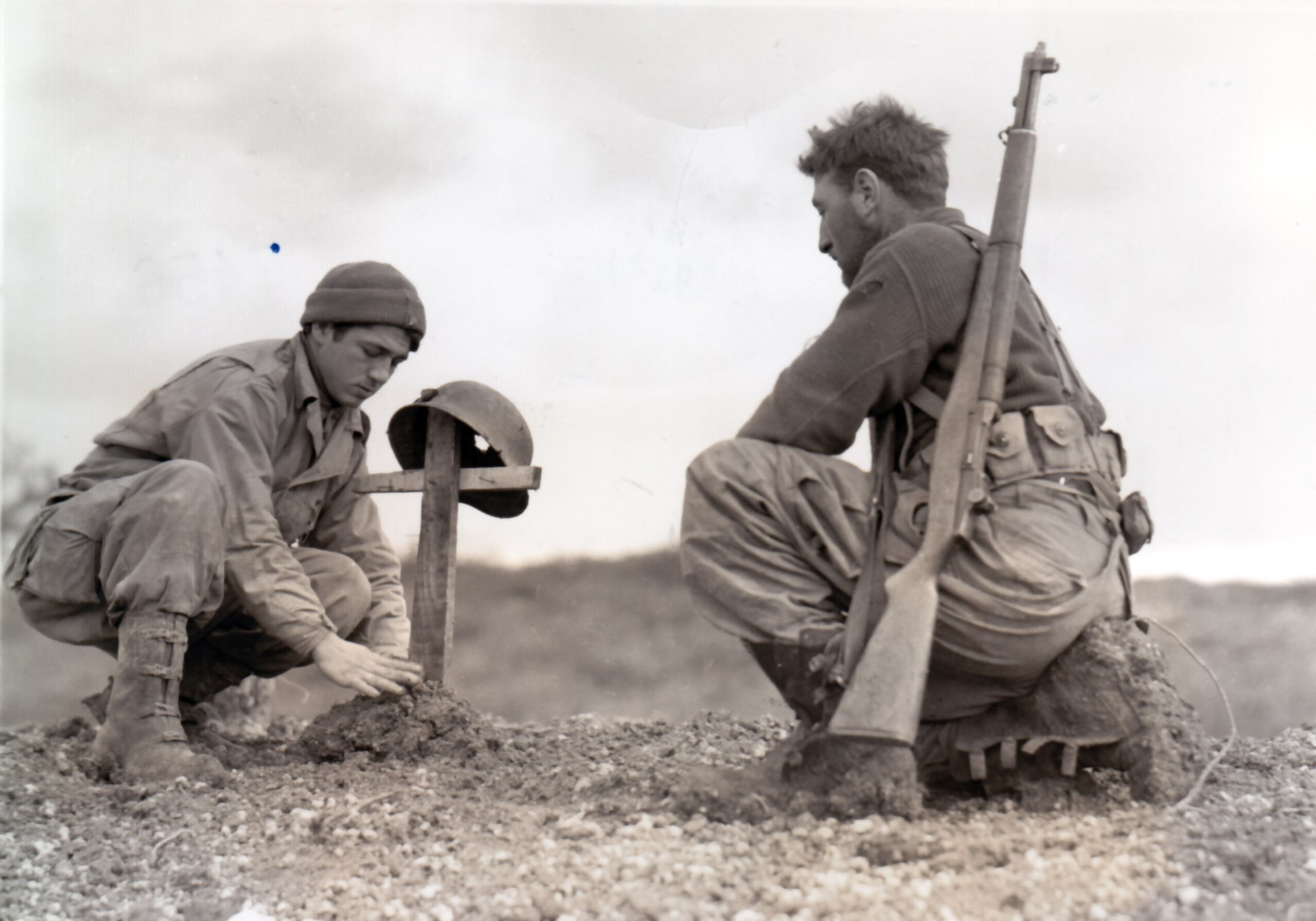 A moment to remember the fallen: FSSF men pause to honor a friend before they move on to the next battle. Anzio area, 1944. NARA