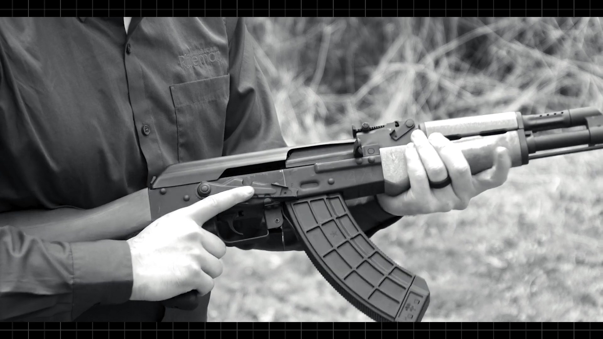 Century Arms BFT47 rifle in hands outdoor shooting black/white image