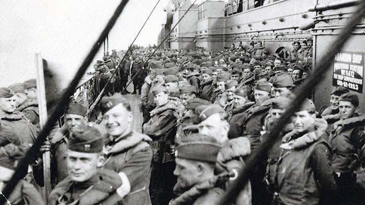 A photo of the men of Company D, 340th Infantry Regiment on a ship headed back to the United States after the war. Capt. McKee is the smiling officer in the second row to the left.