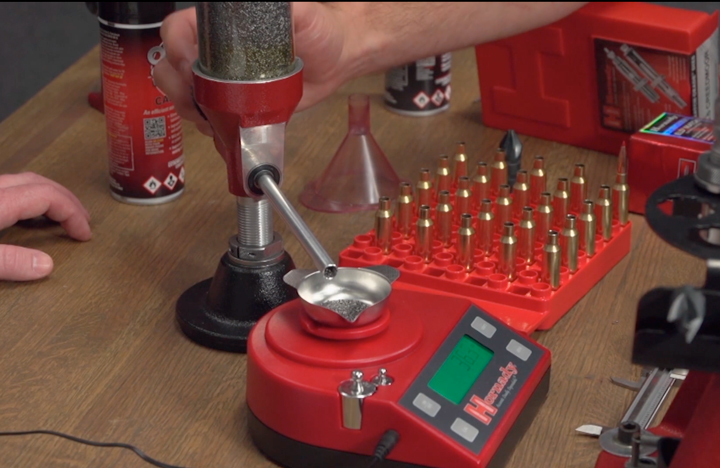 Reloading tools on bench with a gun powder scale.