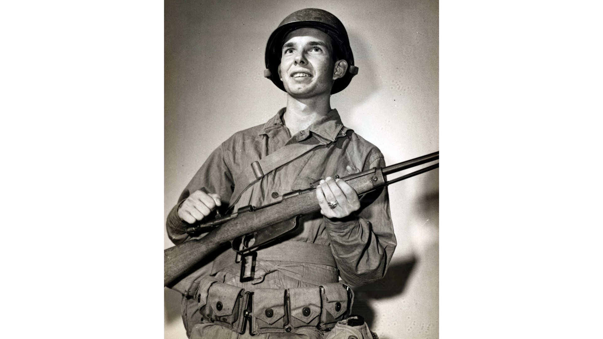 A US Coastguardsman proudly displays his war trophy, an Italian Carcano M91 carbine (6.5x52mm).  NARA