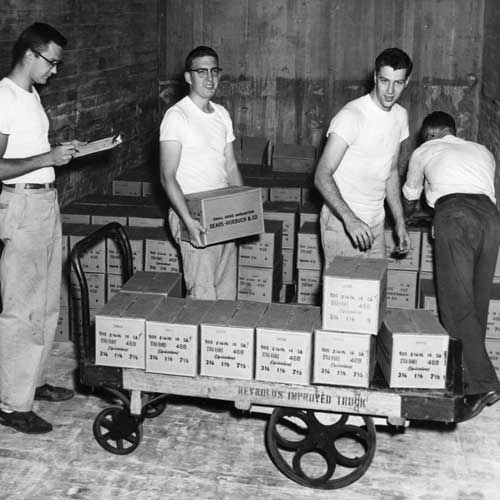 vintage photo men working factory boxes cart loading sales ammunition manufacturing sears