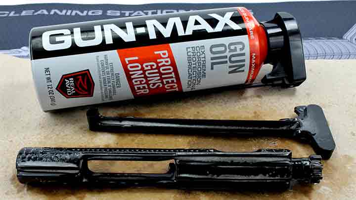 Lubricating the bolt carrier group and charging handle of the AR-15 with Real Avid Gun-Max oil.