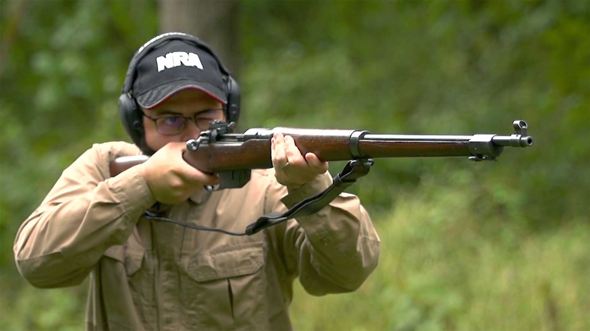 Man aiming the Ross Mk III rifle on an outdoor range.