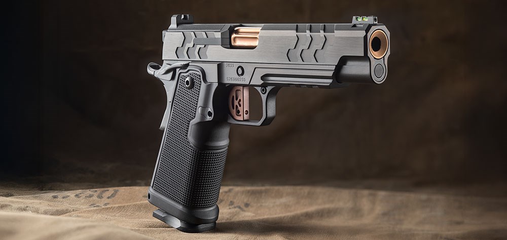 Kimber 2K11 pistol dynamic angled right-side view shown with black gun gold barrel double-stack 1911 pistol 9 mm shown on military canvas