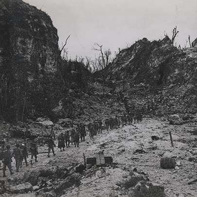 Picking their way through the rocky terrain of the Umurbrogol, a column of Marines moves up to the front lines. From the Photograph Collection (COLL/3948), Marine Corps Archives &amp; Special Collections OFFICIAL USMC PHOTOGRAPH.