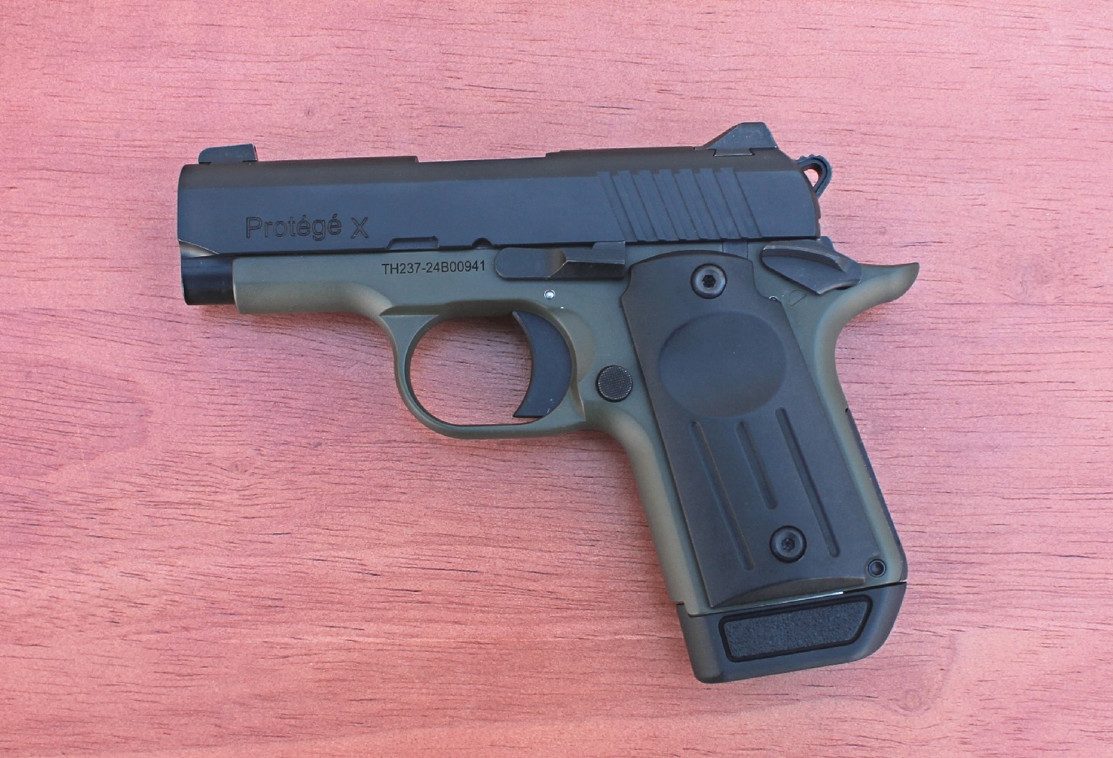 Full left side view of the TriStar Arms Protege X with an OD green frame and black slide.