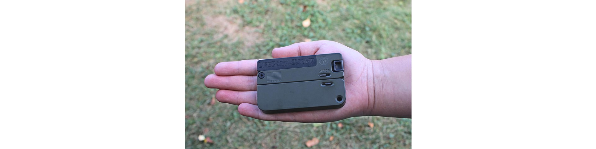 small folding gun in hand outdoors