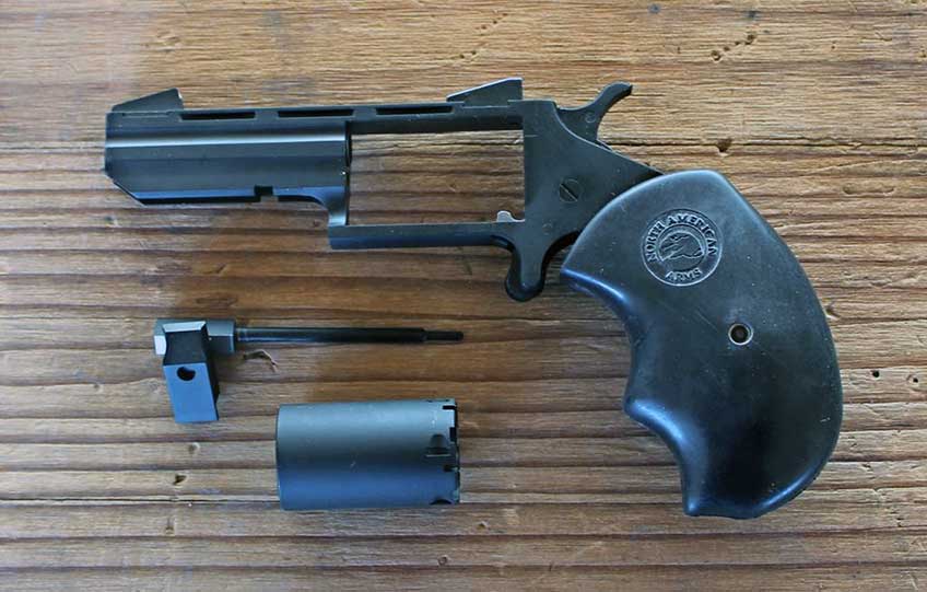 left side NAA Black Widow handgun revolver fieldstripped disassembled gun on table