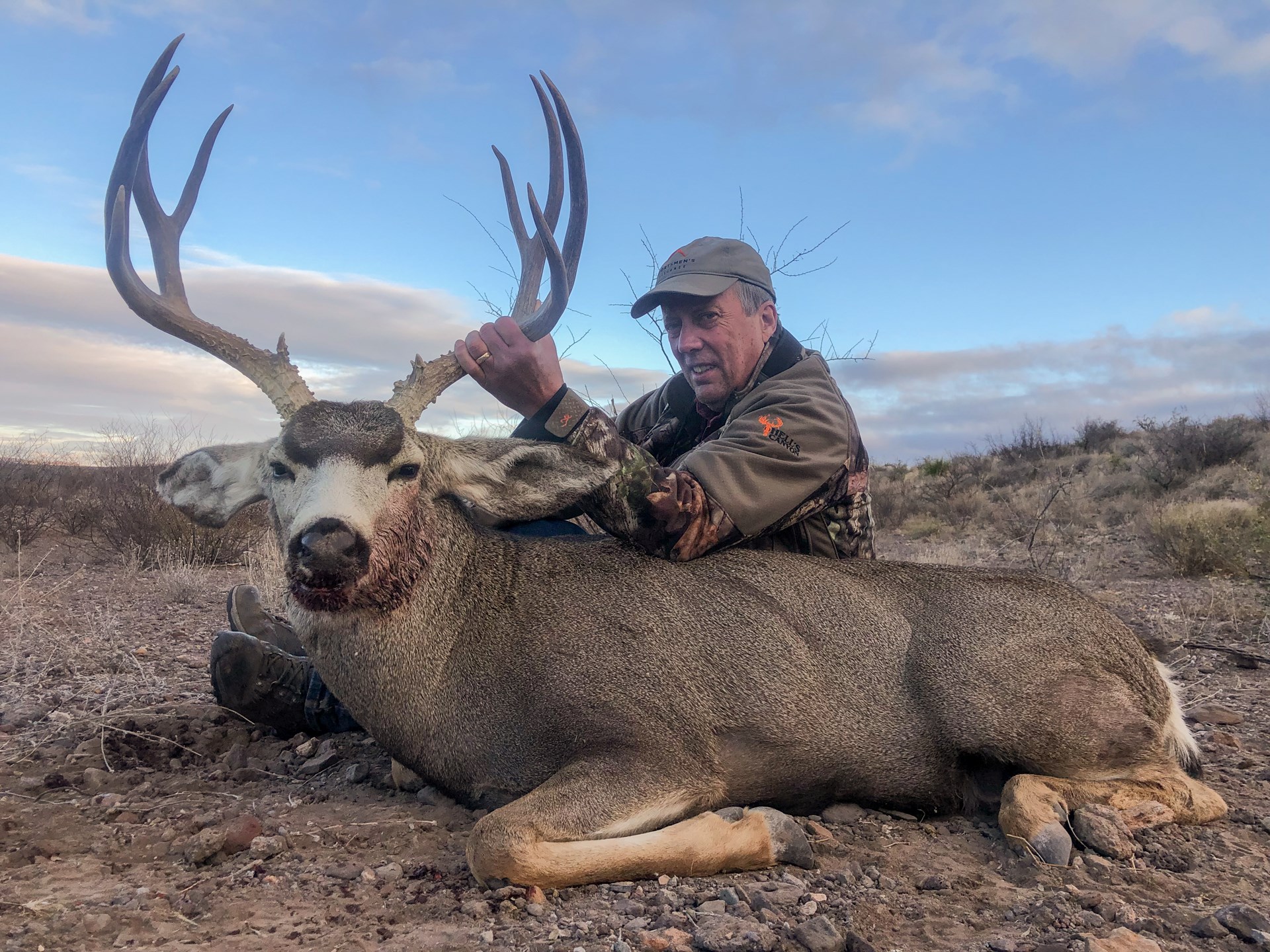 John Haviland, author, man outdoors camouflage deer hunter mule deer dead animal large anters rack bone