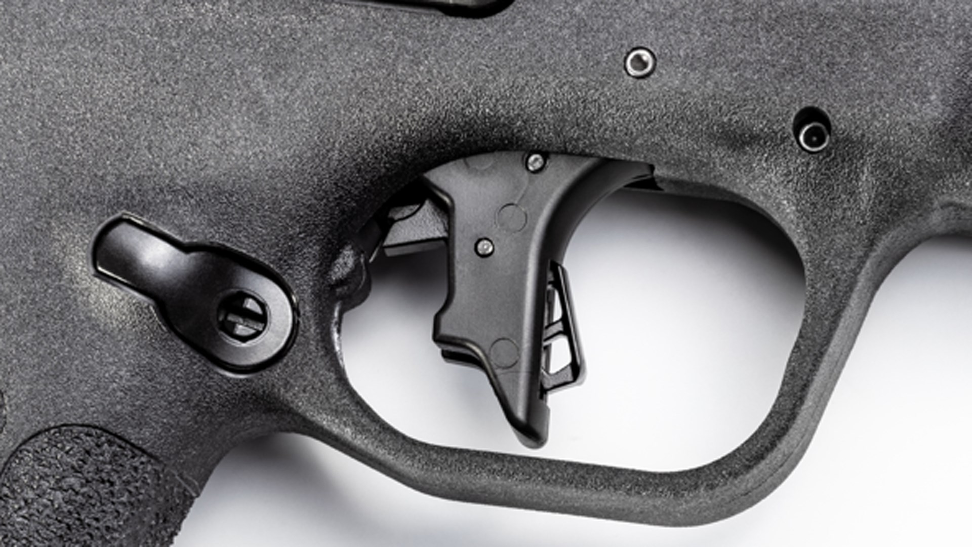 A close-up view of the black trigger on the Smith & Wesson M&P 22 Magnum.