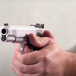 Man shooting gun target stainless steel M1911 range indoors remote camera 