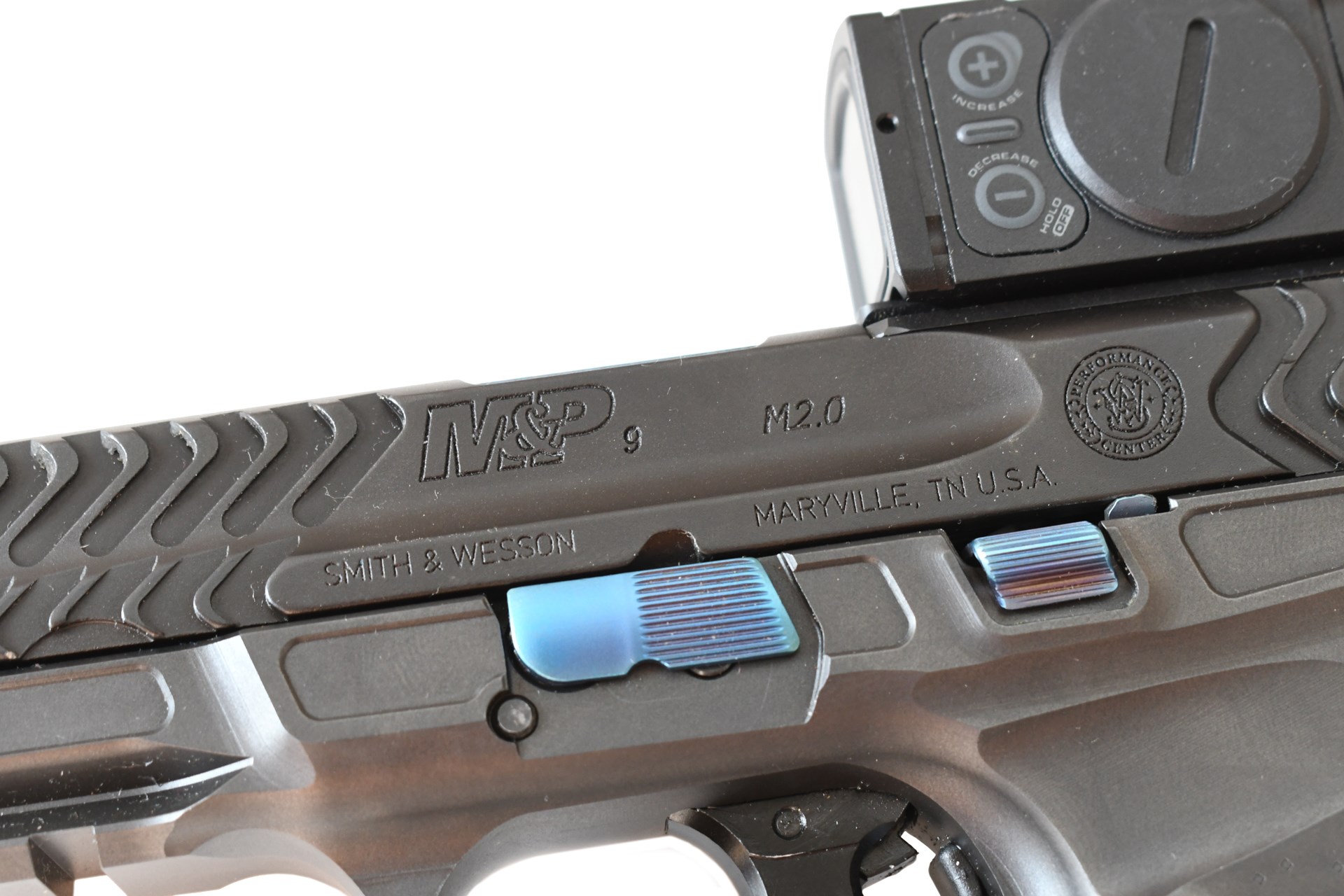 Smith & Wesson Spec Series V M&P 9 Metal HD pistol left-side close-up view slide stamping blue controls aimpoint red-dot top right