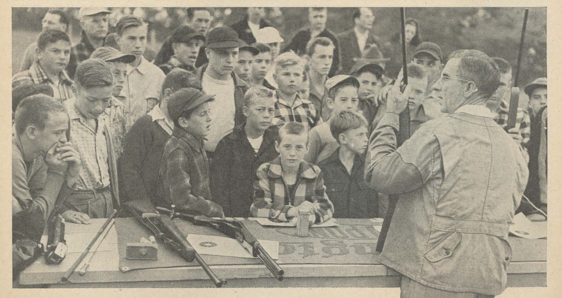 Group of people youngsters kids learning outdoors marksmanship instruction firearm safety