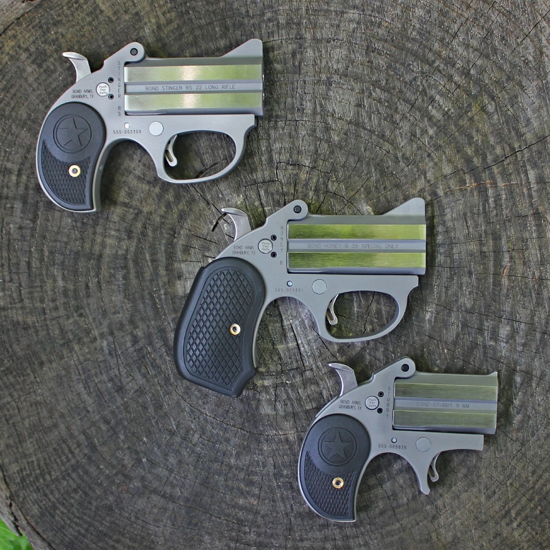 Three bond arm derringer double-barrel pistols on wood log New Stinger RS model options include the .22 LR version (top), the Honey B .38 Spec. (center) and the Stubby 9 mm (bottom).