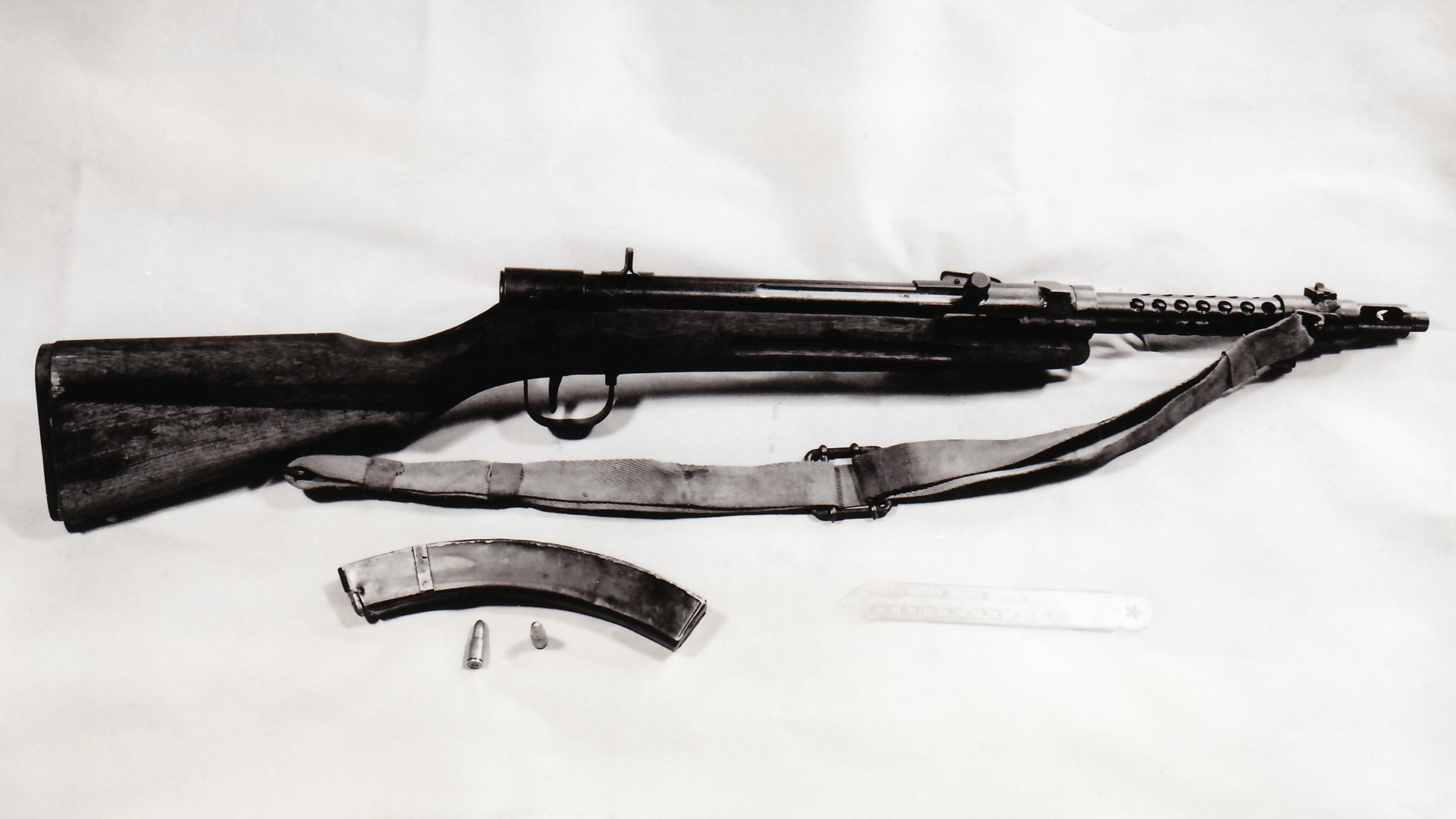 Japanese Type 100/44 submachine gun right-side view shown with sling and magazine and ammunition