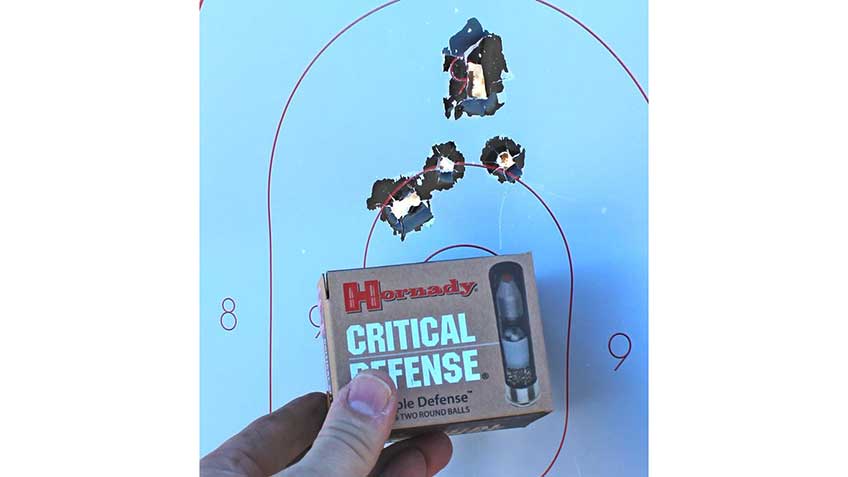 hornady critical defense ammunition box and target hand fingers holes paper grouping accuracy
