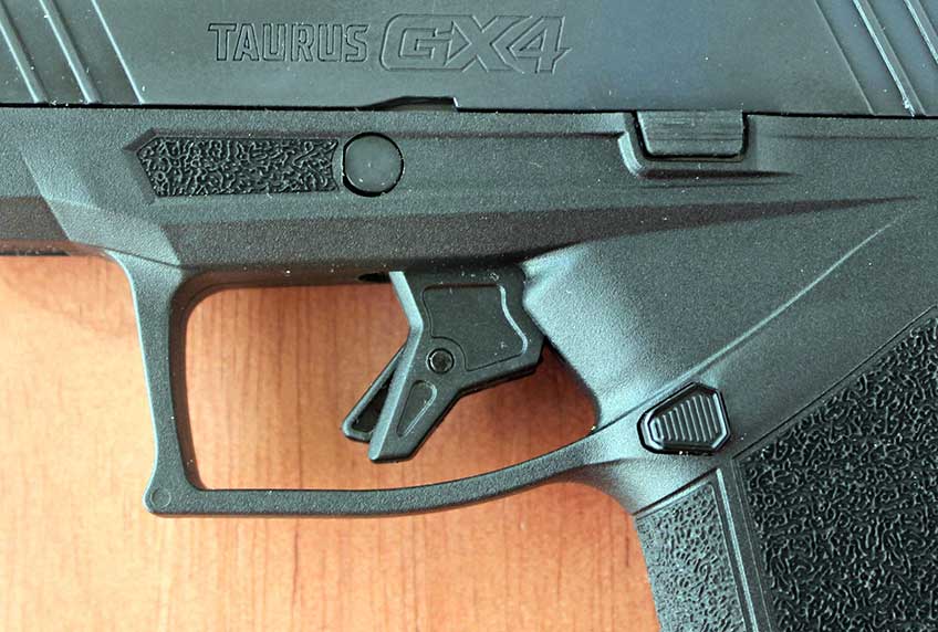 Taurus GX4 trigger close-up view plastic frame metal slide stamping stippling ergonomics