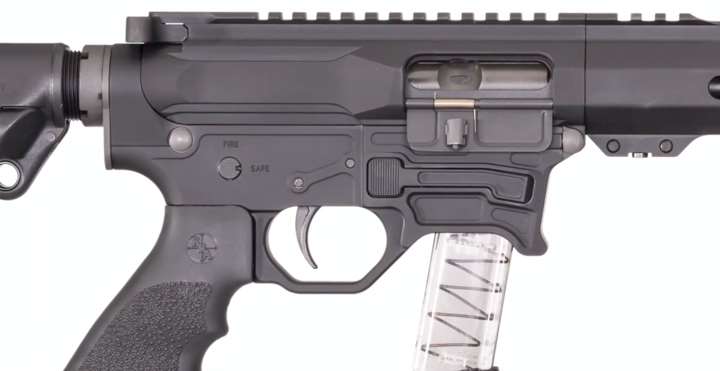 Close-up view of the right side of a Rock River Arms 9 mm shown with clear magazine on a white background.