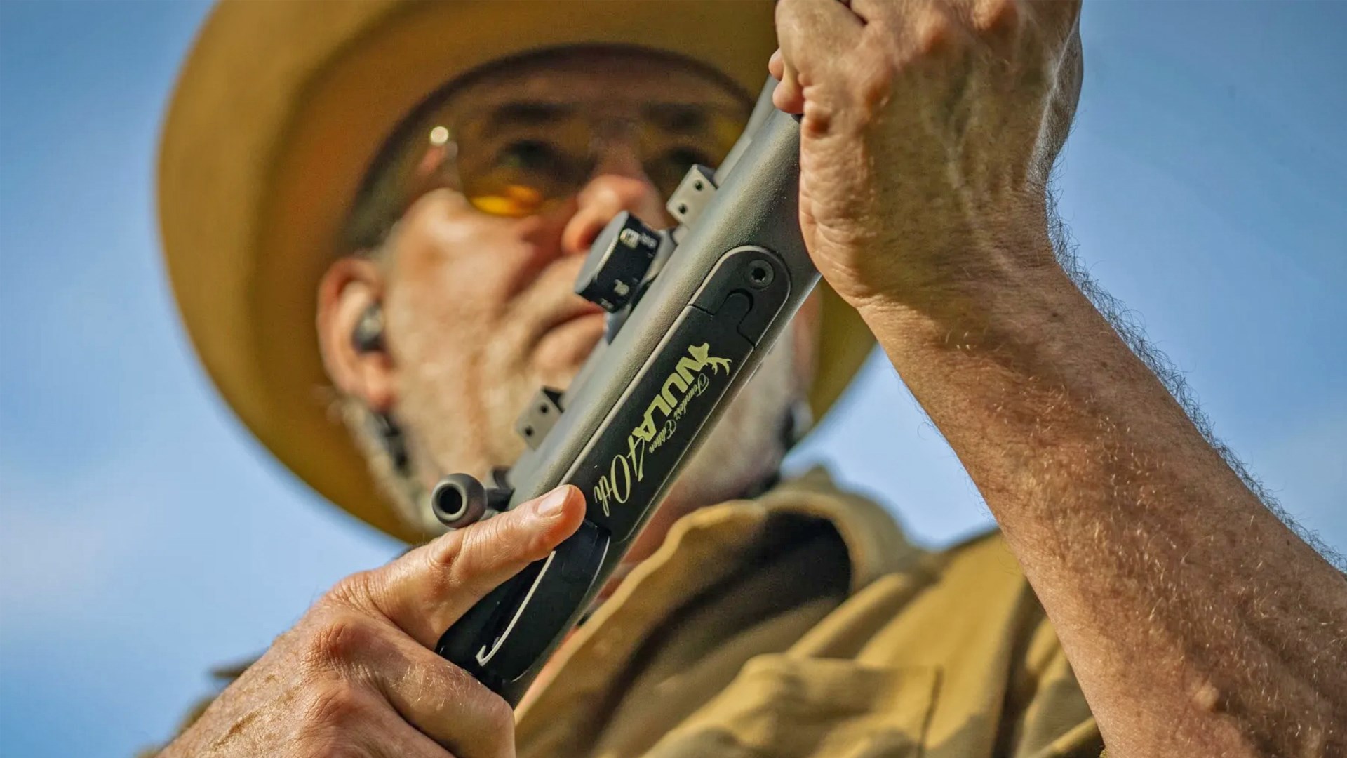 Bottom of the New Ultra Light Arms rifle as it is held in a ready position by a male hunter.