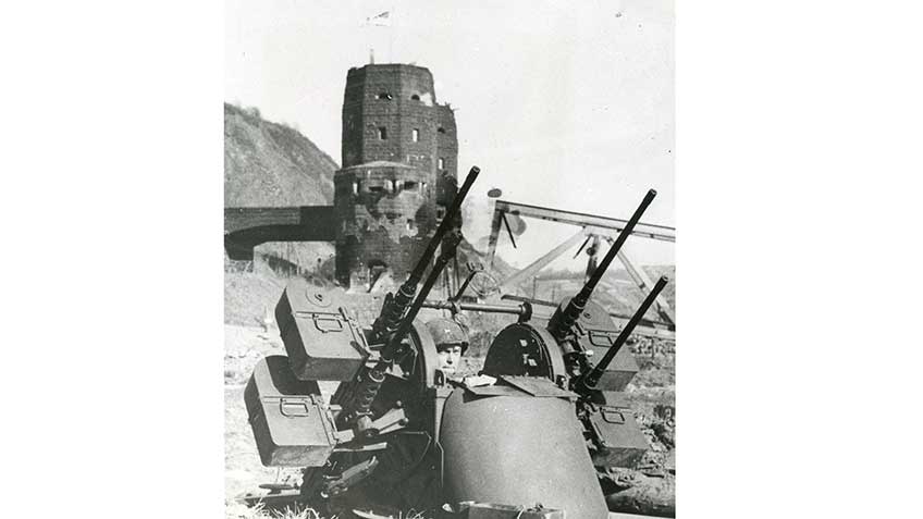Clouds of .50 caliber slugs filled the skies in the narrow approaches to the bridge.  An M45 .50 caliber Quadmount  (2,300 rounds per minute via its 4 Browning MGs) awaits the Luftwaffe’s next attack.