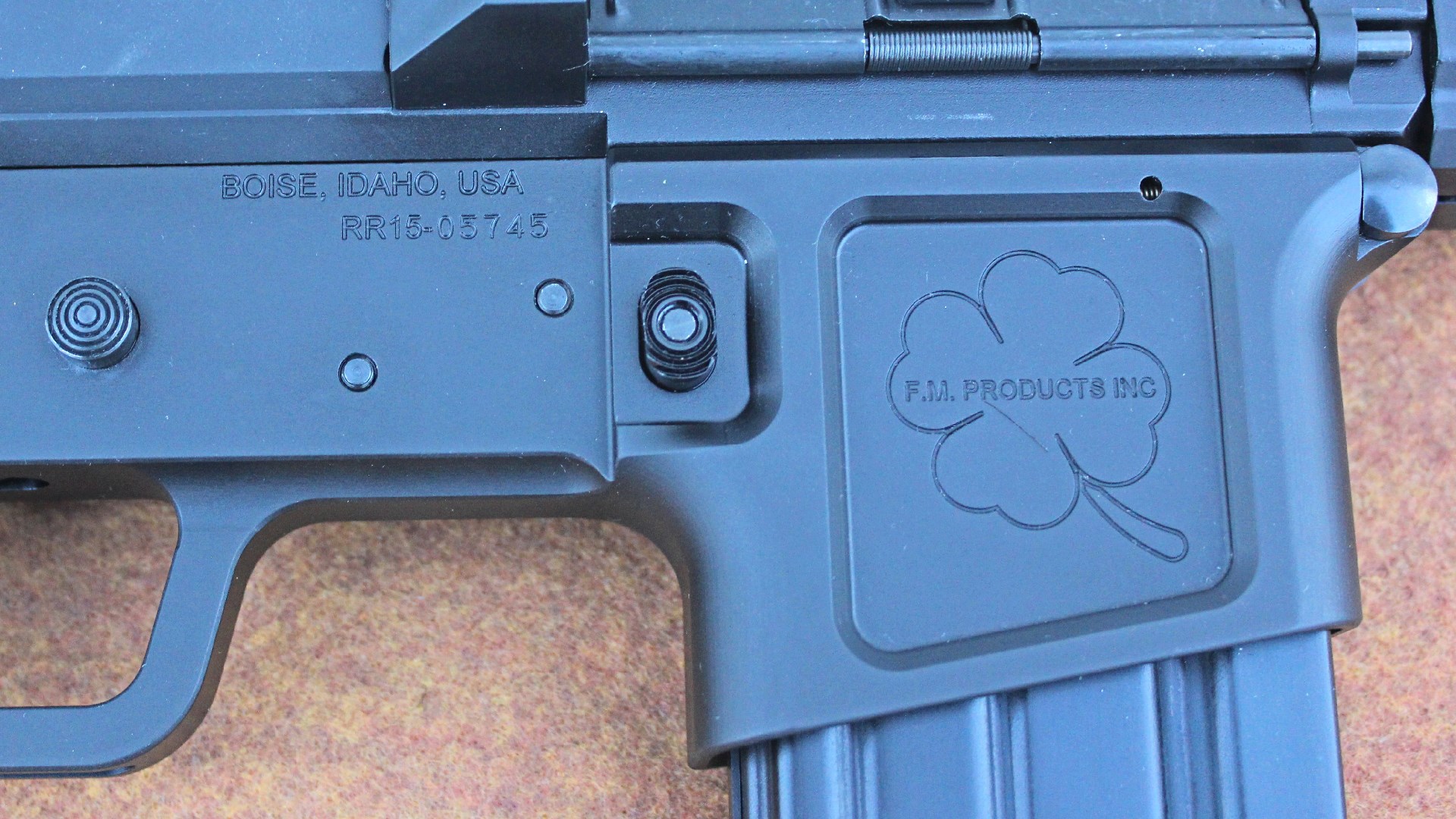 FM Products Rancher Rifle right-side receiver closeup showing markings stamping in black aluminum four-leaf clover
