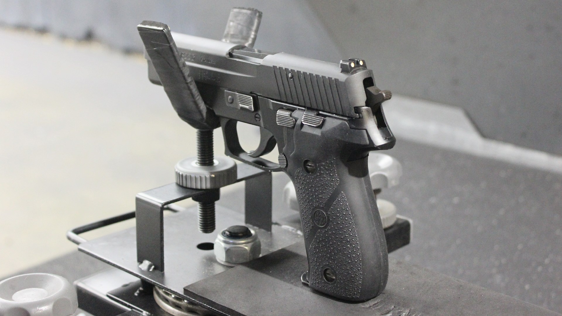SIG Sauer P226 in shooting rest cradle