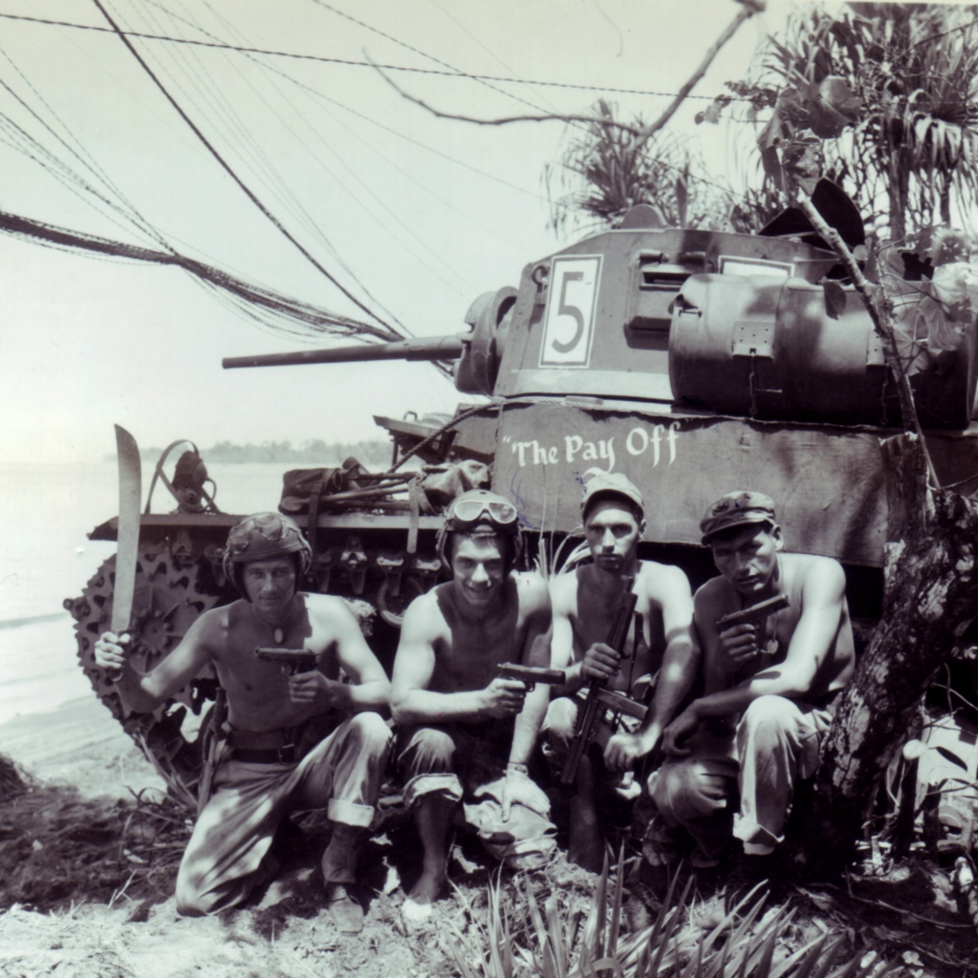 Marine tankers pose with the personal weapons beside their M3 Stuart light tank. Bougainville, late 1943.