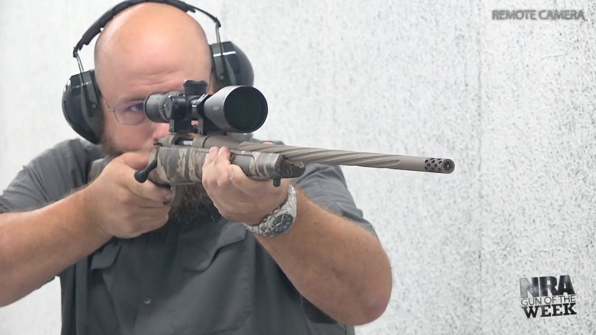Man on shooting range with bolt-action Weatherby Vanguard First Lite Cipher hunting rifle