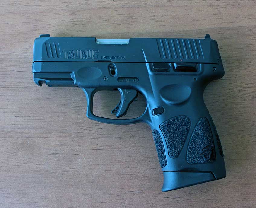 left side Taurus G3c handgun semi-automatic 9 mm pistol on table