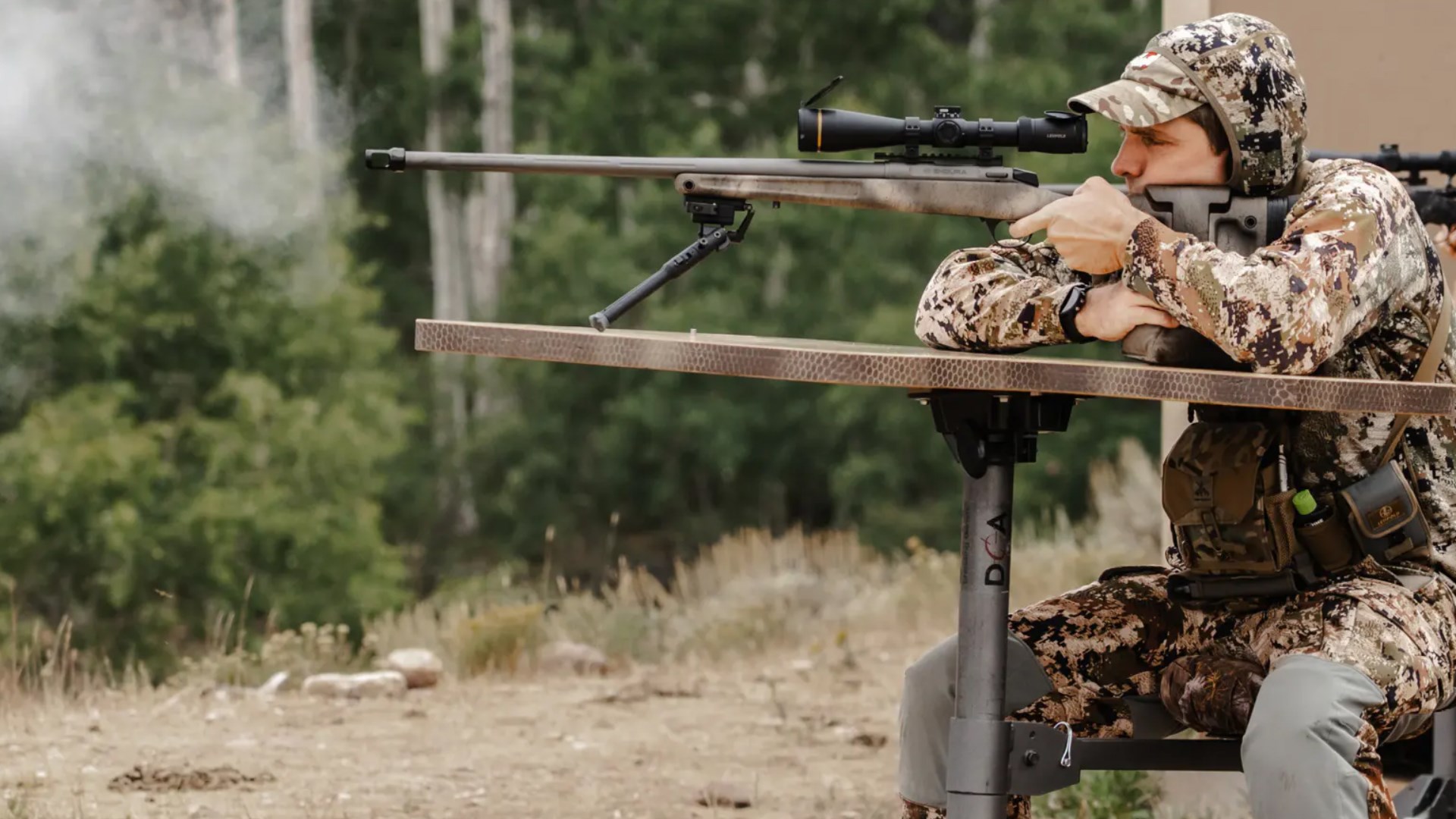 Man shooting the CVA Endura muzzleloader from a shooting bench on an outdoor range.