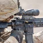 a Marine takes aim with the M27 rifle