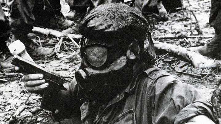 The war underground:  A “Tunnel Rat” descends into a VC tunnel wearing a gas mask while armed with a M1911 pistol and tremendous courage.