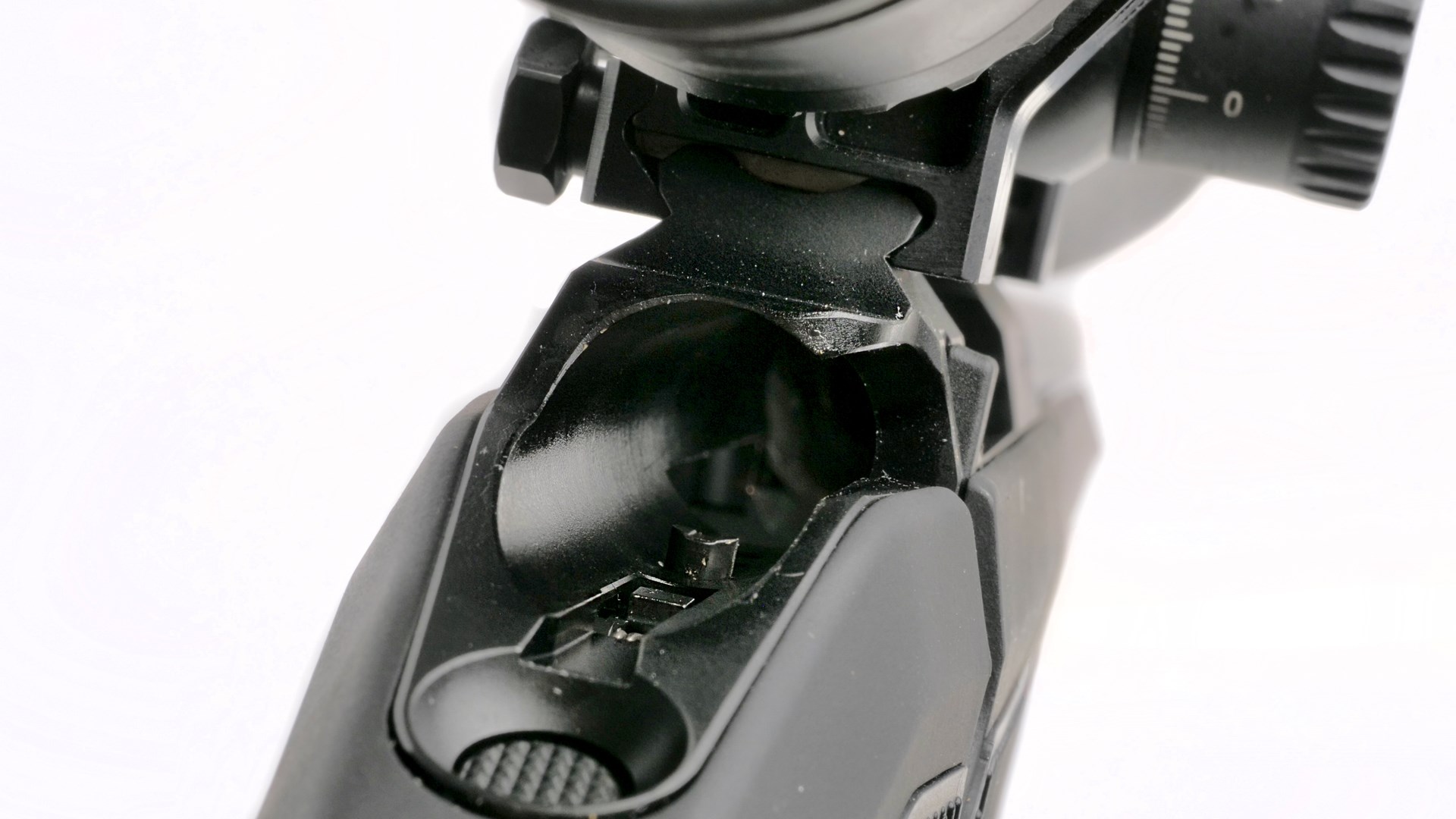 Rear view of CZ 600 bolt-action rifle receiver with bolt removed showing integral Picatinny rail safety button and riflescope mount