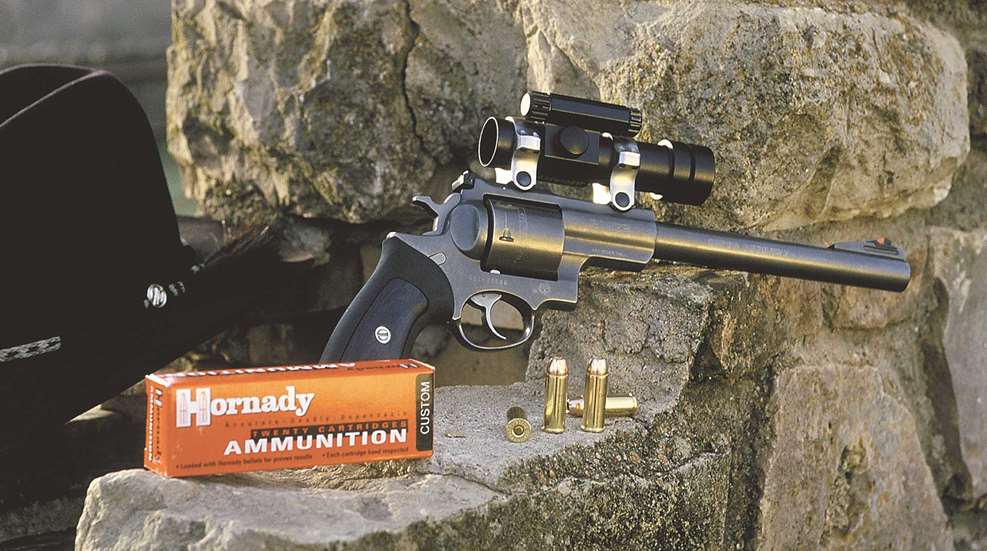 Rocks outdoors vantage hunting handgun pistol ammunition brass red box black hat sunset
