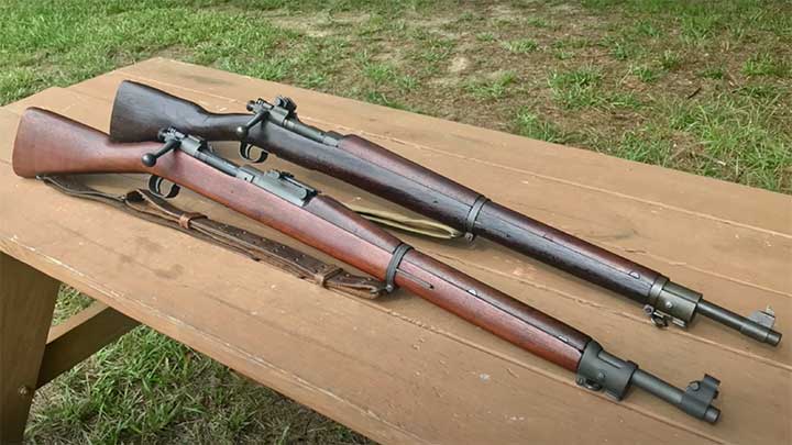 Two Remington produced M1903 rifles, with a standard style M1903 in the foreground and a simplified M1903A3 in the background.