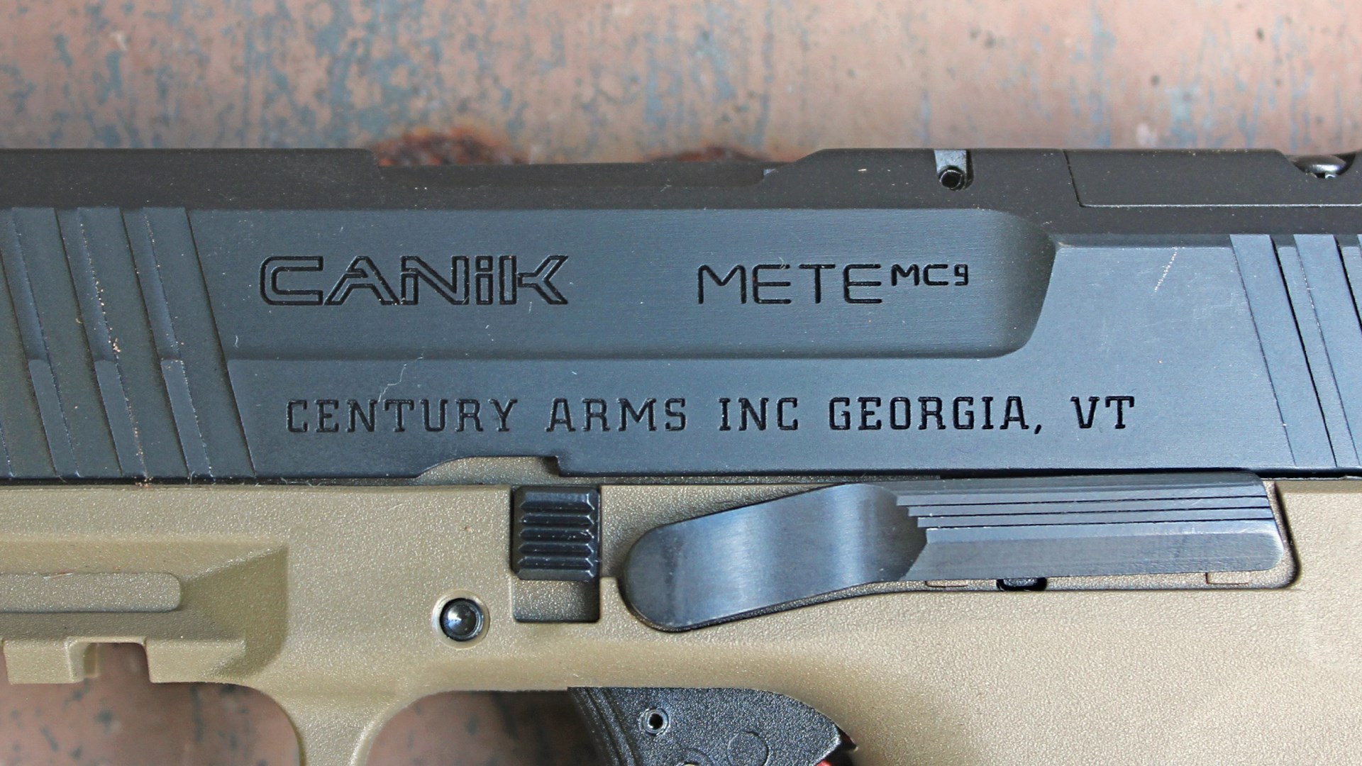 "canik mete mc9 century arms inc georgia, vt" stamping on black steel pistol slide