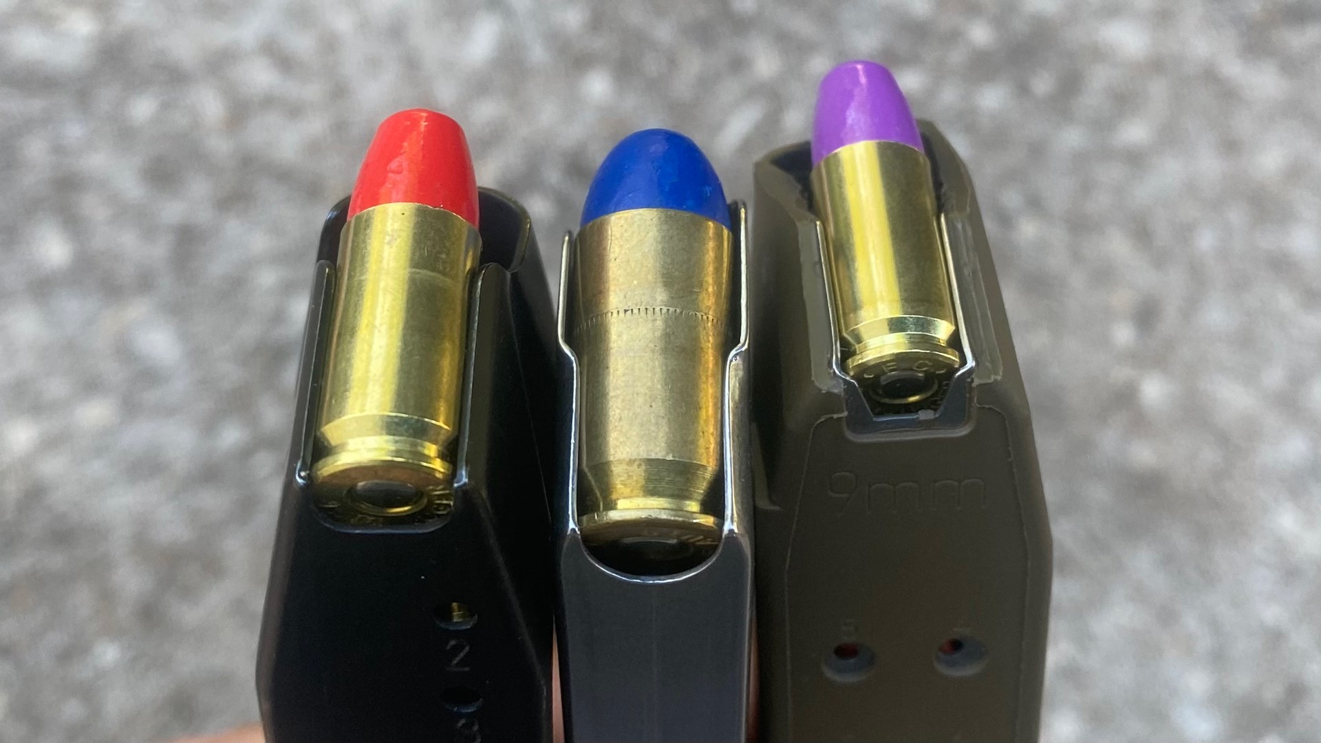 coated bullets red blue ammunition magazine three left to right stack