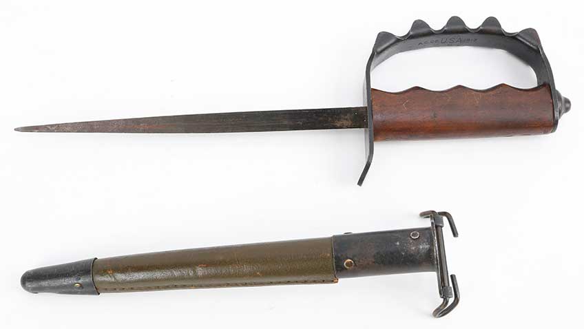 Right-side view of American Cutlery Co. of Chicago fighting knife with walnut grip and blued 9” triangular bladed. Shown with scabbard on white background.