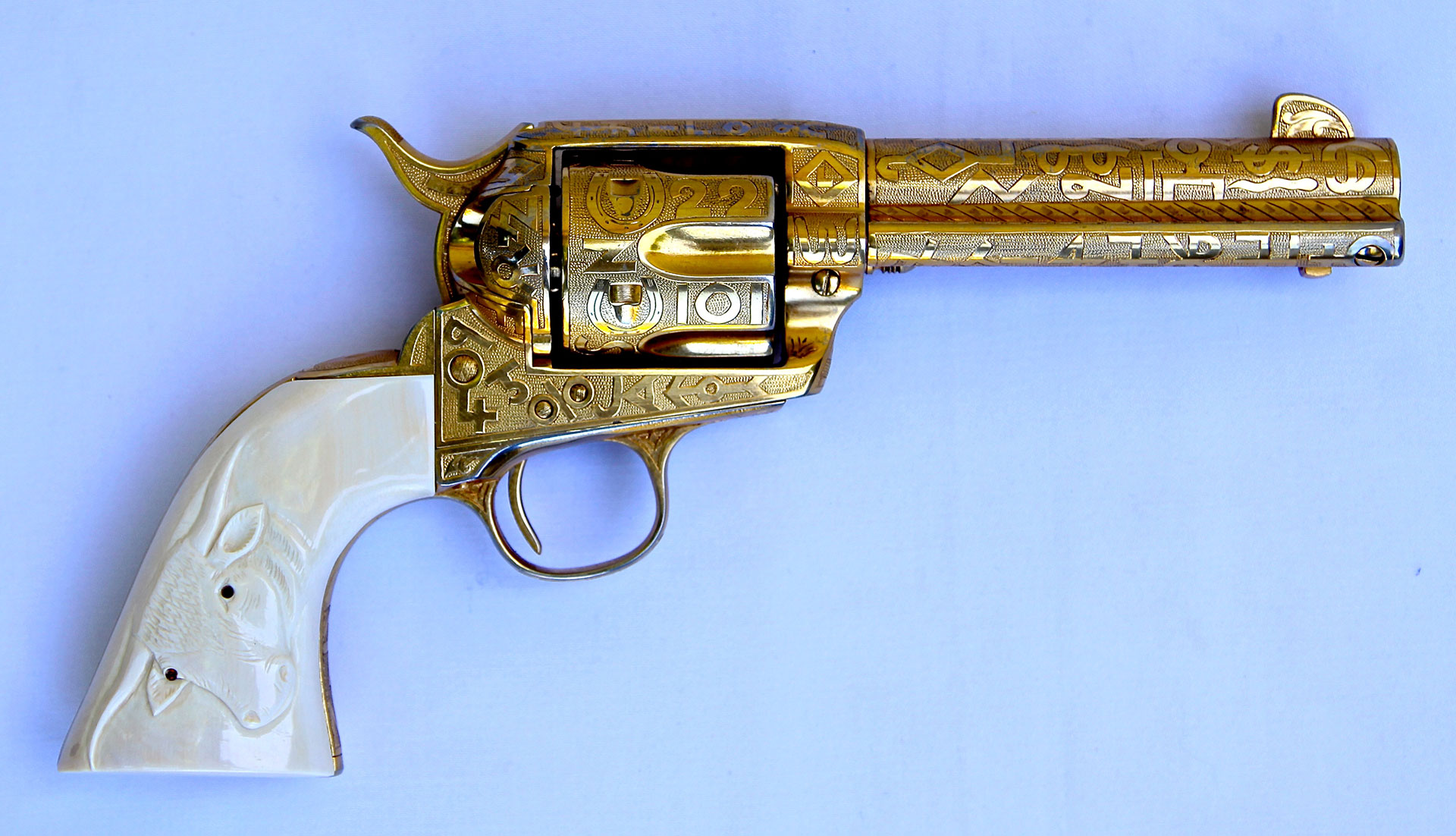 A Cole Agee-engraved and gold plated .45-cal. cattle brand Colt Single Action Army with aftermarket one-piece carved ivory grips.
