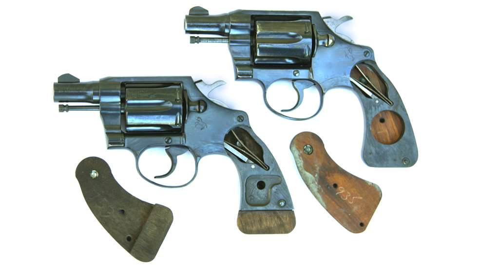 Two colt revolver left-side view with grips stocks wood removed signify size difference compatibility.