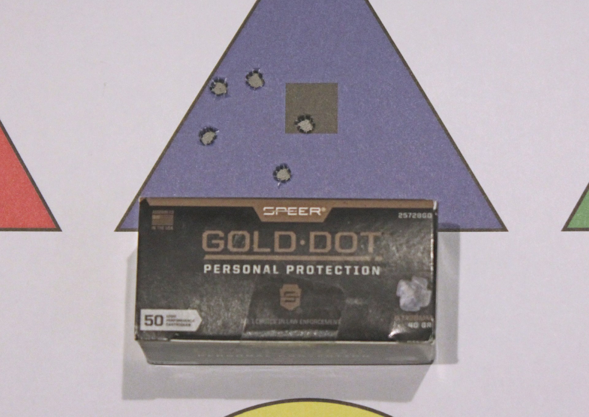 Speer Gold Dot ammunition box with target triangle bullet hole group accuracy testing