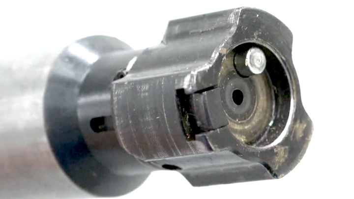 Up-close view of a three-lug rifle bolt shown on white background.