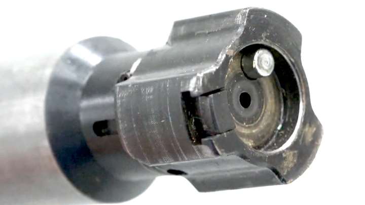 Up-close view of a three-lug rifle bolt shown on white background.
